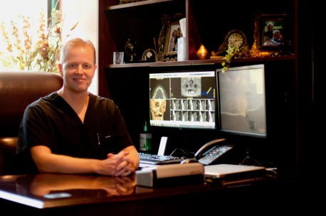 Dr. Bradley Hammond sitting at his desk