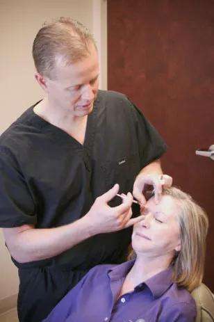 Dr. Hammond injecting a patient