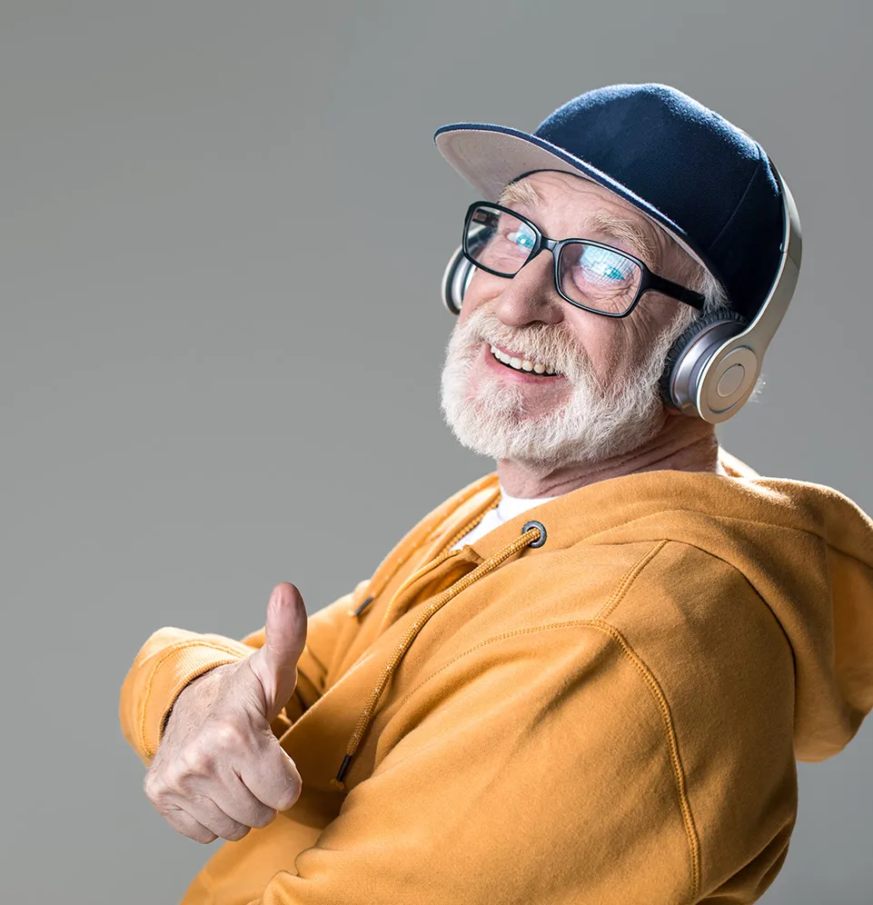 smiling elderly man giving a thumbs up