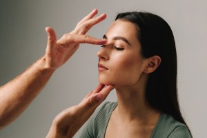 woman getting checked by doctor before rhinoplasty